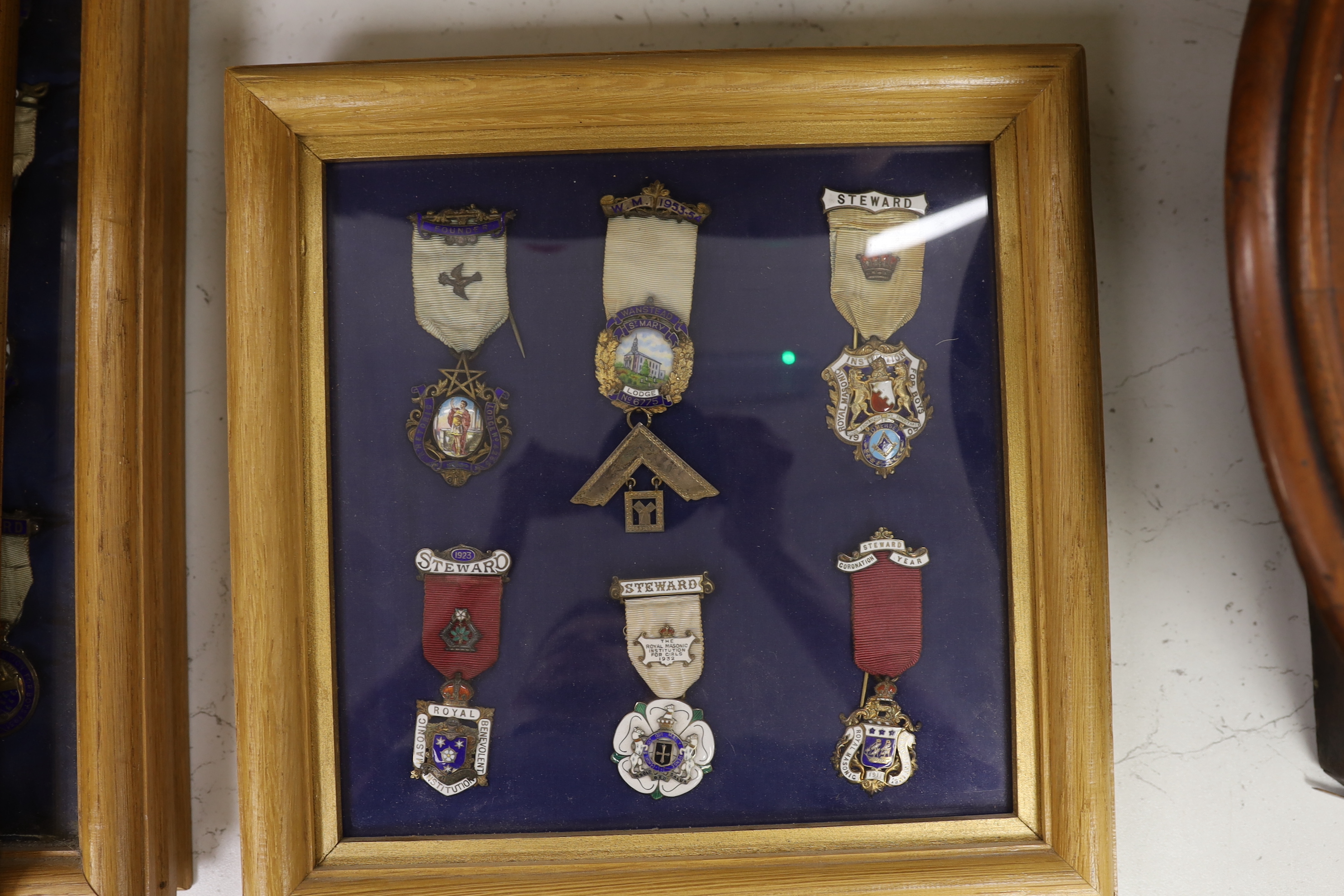 A collection of 20th century enamelled silver gilt or gilt metal Masonic medals with ribbons and clasps, approx. 47 in silver, and similar badges (mounted in 10 cases)